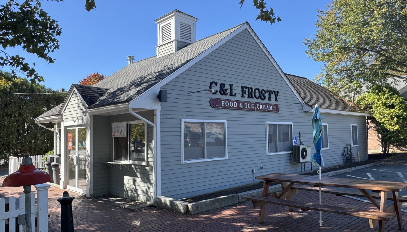C&L Frosty’s gray clapboard building with its cupola, walk-up window, and picnic table on a brick patio