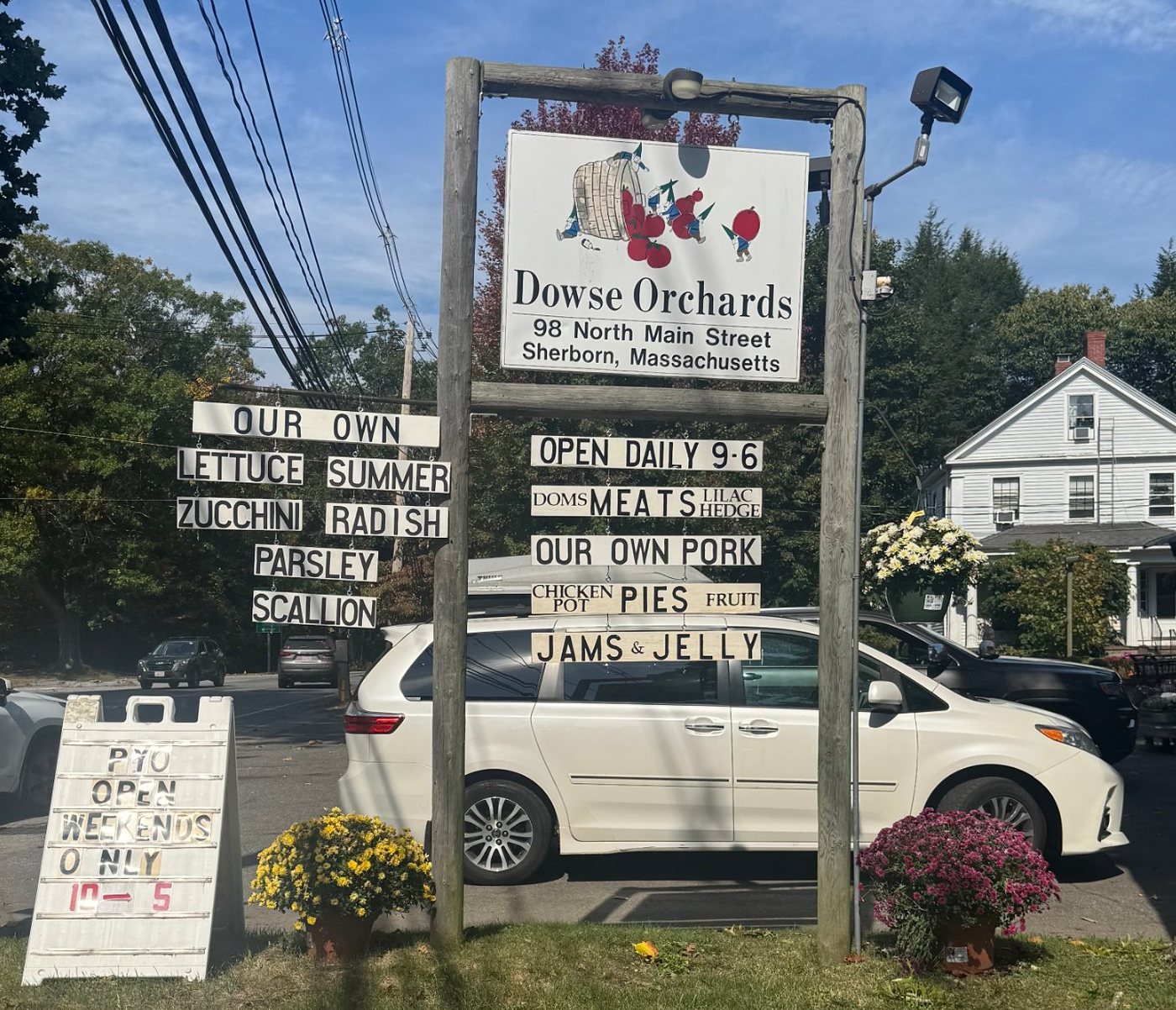 The Dowse Orchards roadside sign at 98 North Main Street, listing the farm’s own vegetables, pork, pies, and jams