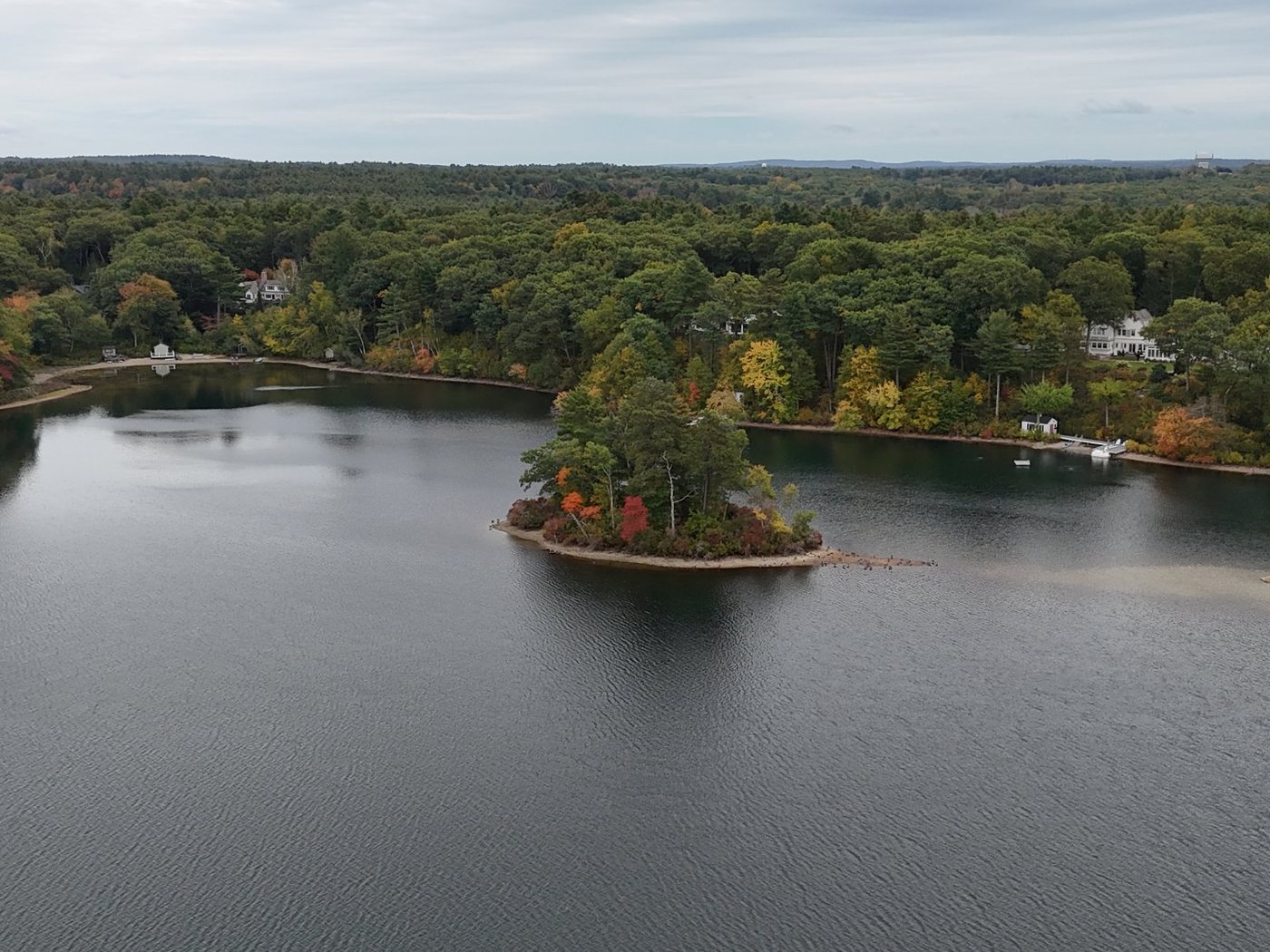 A small wooded island in Farm Pond with fall color along the shore