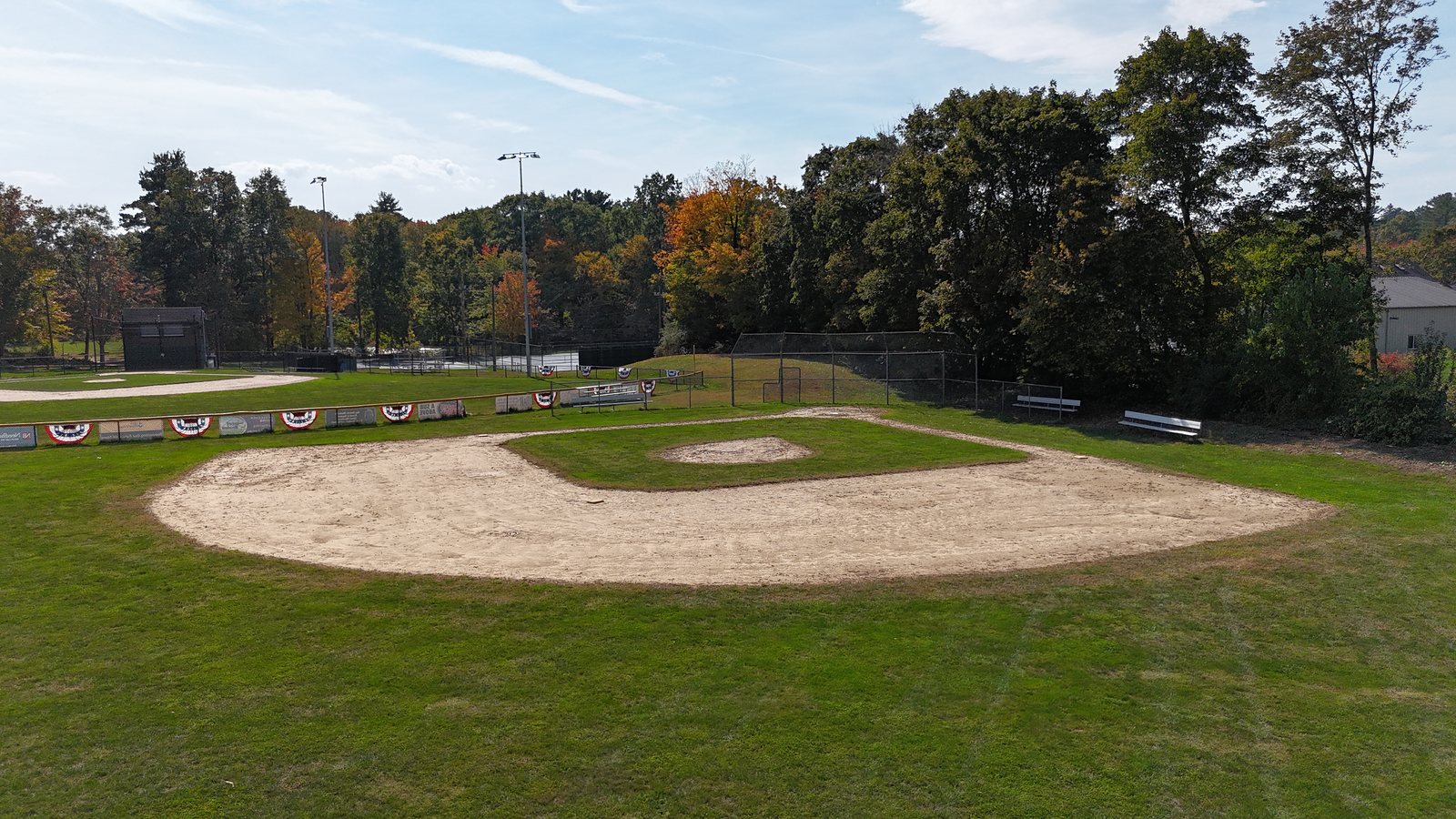 Aerial view of the smaller youth baseball diamond at Jameson Fields, with Field 1 and its lights in the background