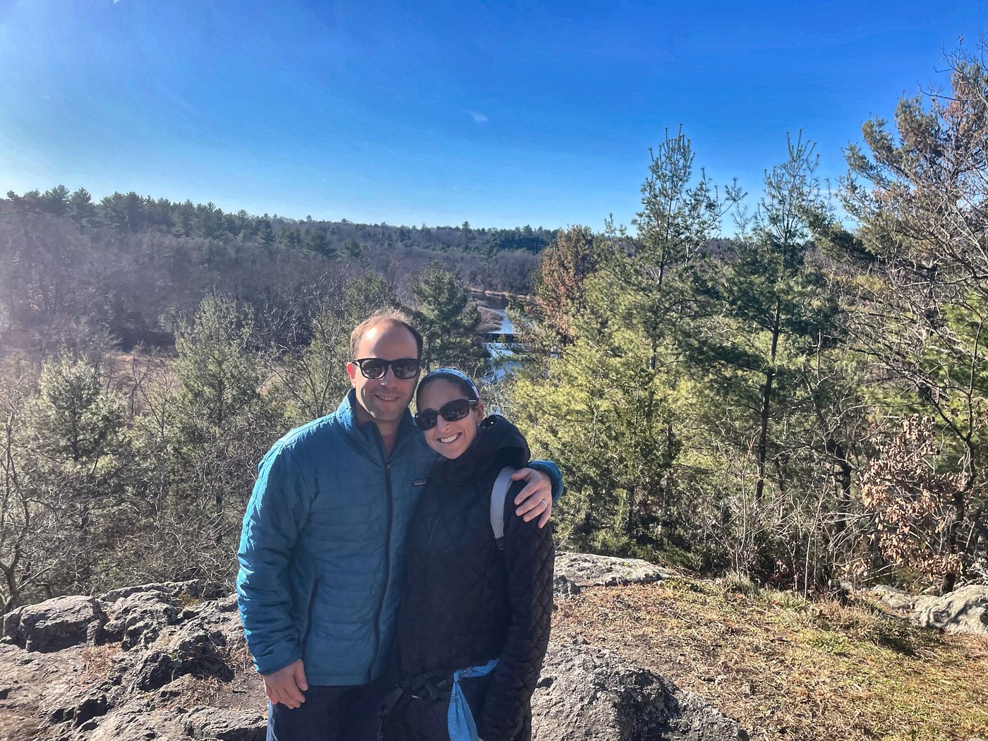Two hikers at King Philip’s Overlook with the Charles River valley behind them