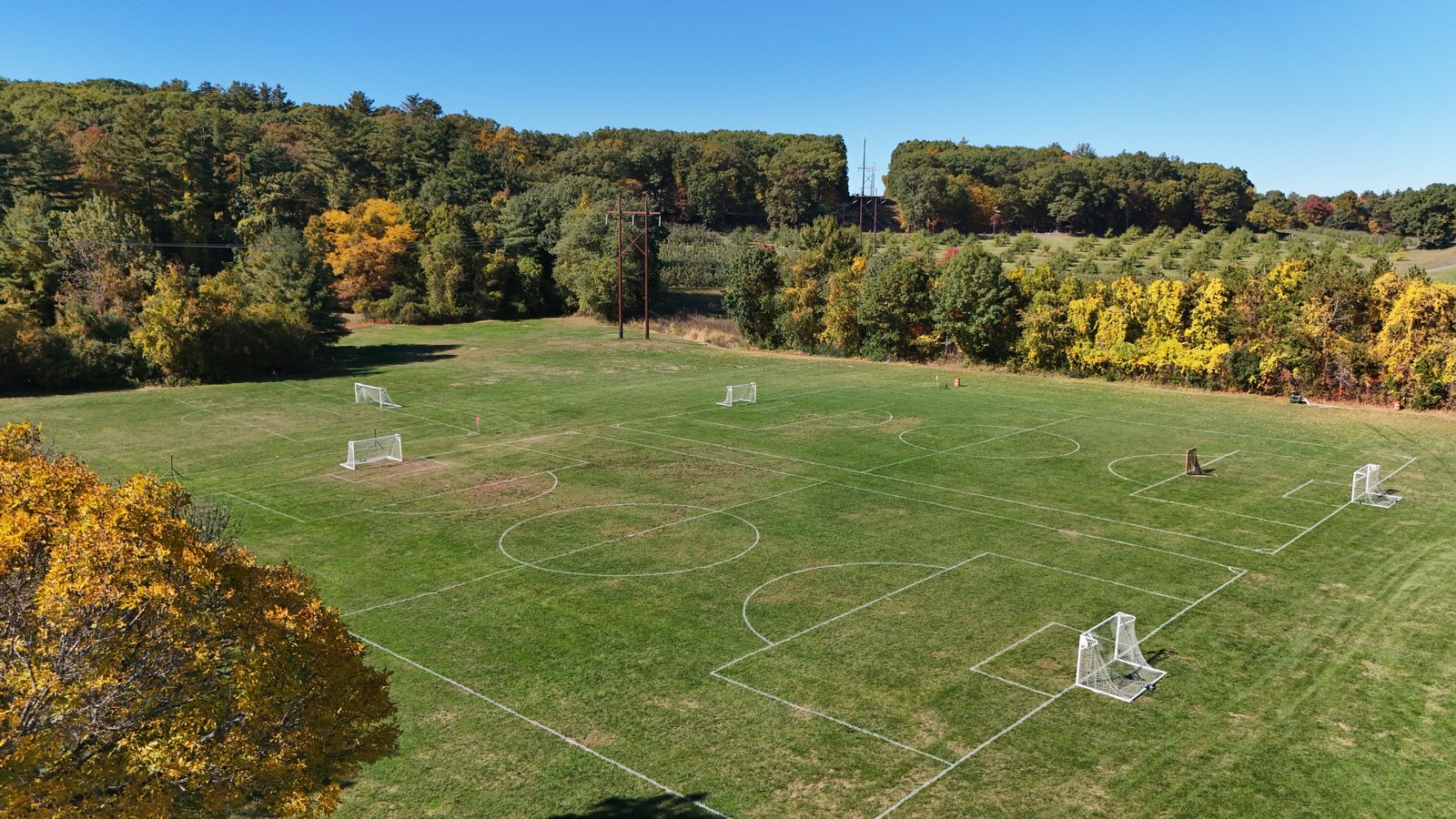 Aerial view of the lined youth soccer fields at Laurel Farm, edged by fall foliage
