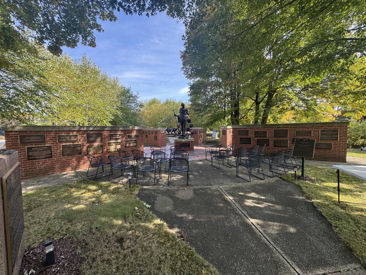 The Pacifist Memorial in Peace Memorial Park, with a bronze statue of Gandhi framed by brick walls lined with bronze plaques